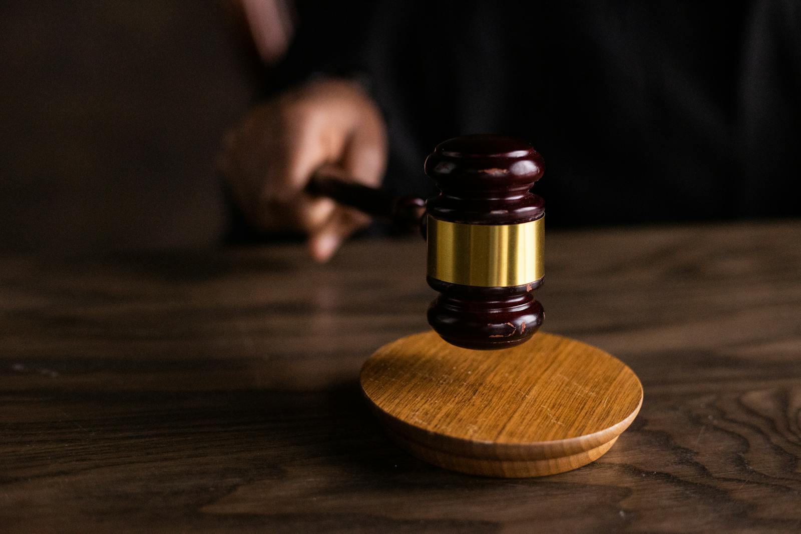 top view of green marijuana leaf with wooden gavel on green background